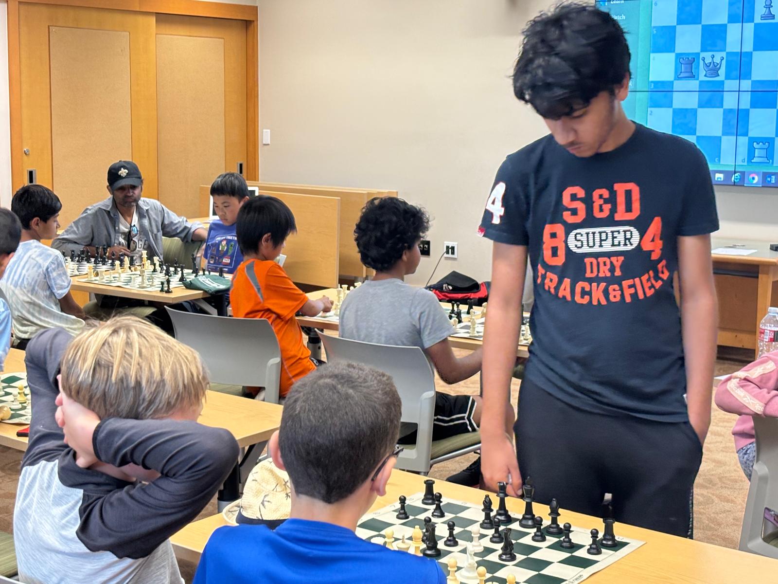 Group of attendees learning chess